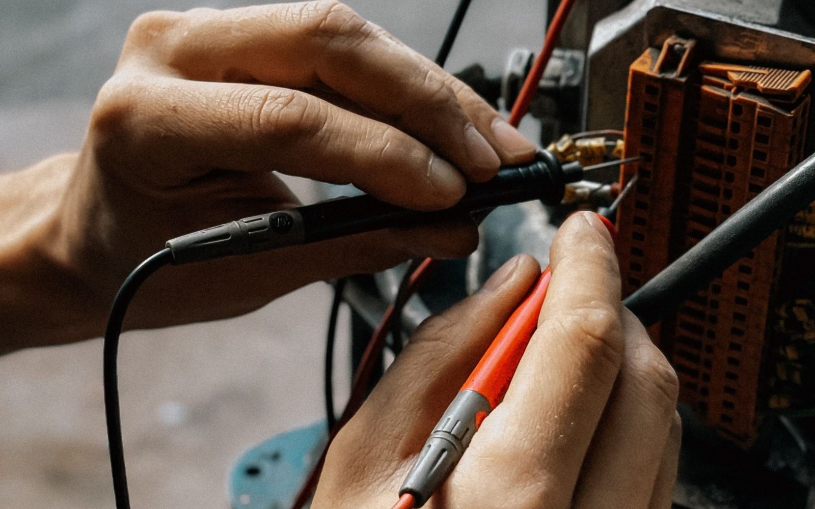 Technician testing wiring with probes